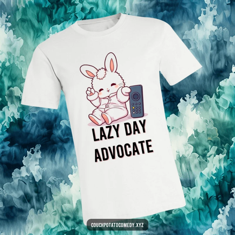 Funny t-shirt featuring a fluffy bunny in oversized pajamas, stretching a paw towards a remote, celebrating lazy days and comfort.
