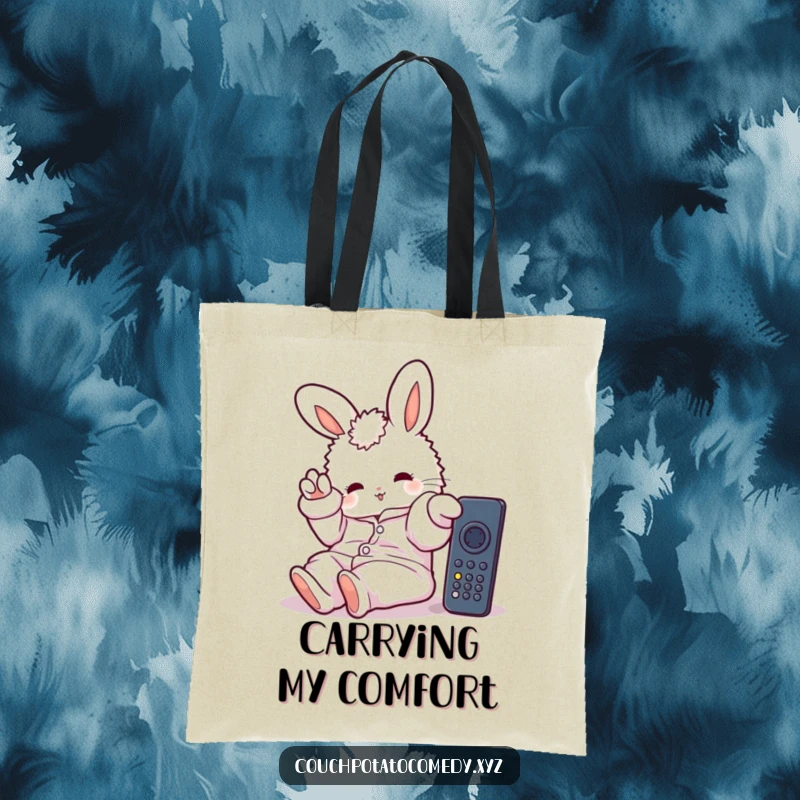 Funny tote bag featuring a fluffy bunny in oversized pajamas, lazily stretching a paw towards a remote, perfect for errands or relaxation essentials.